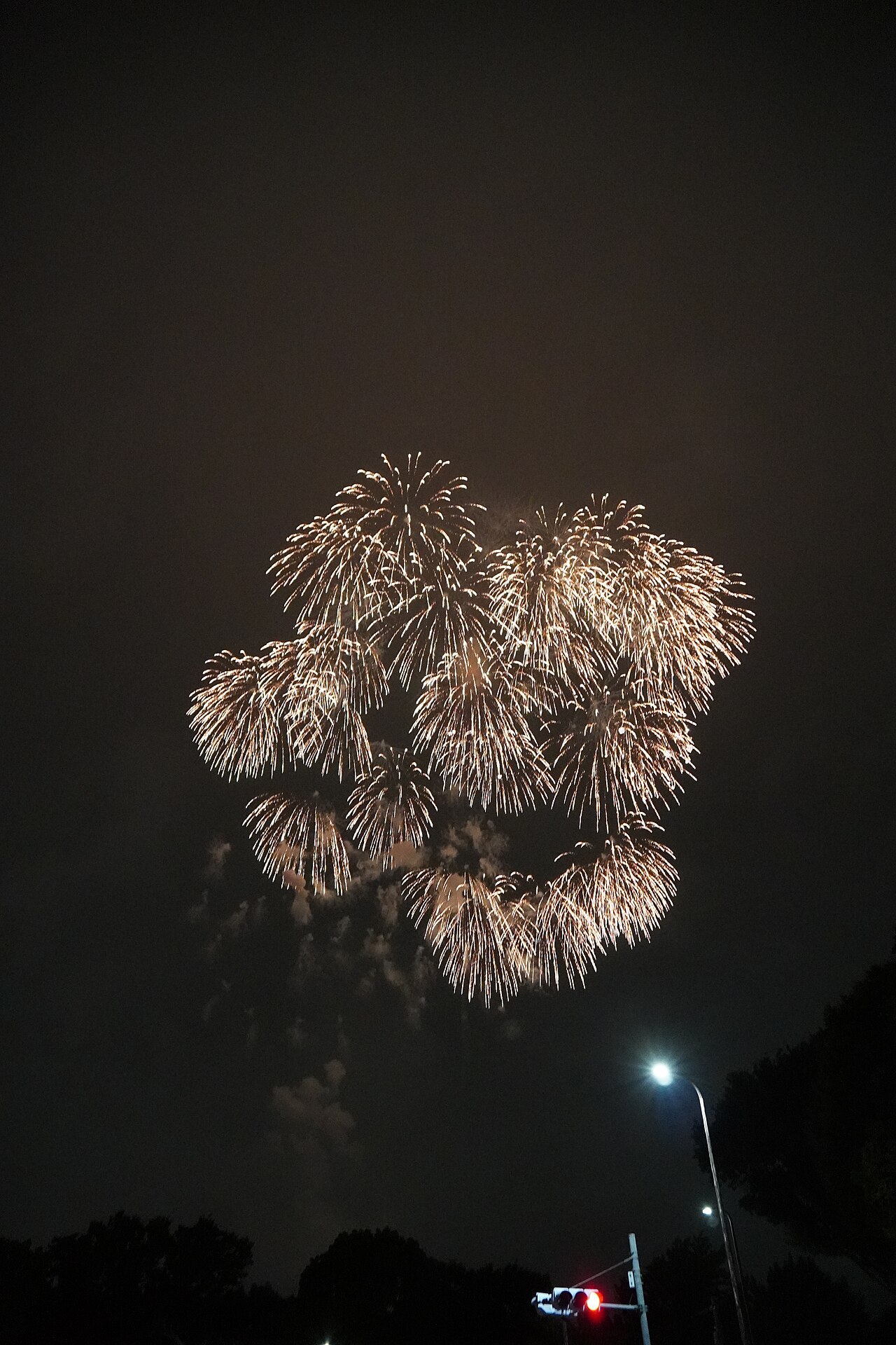 Golden fireworks over Tachikawa on 25 July 2026, seen from a street near the venue