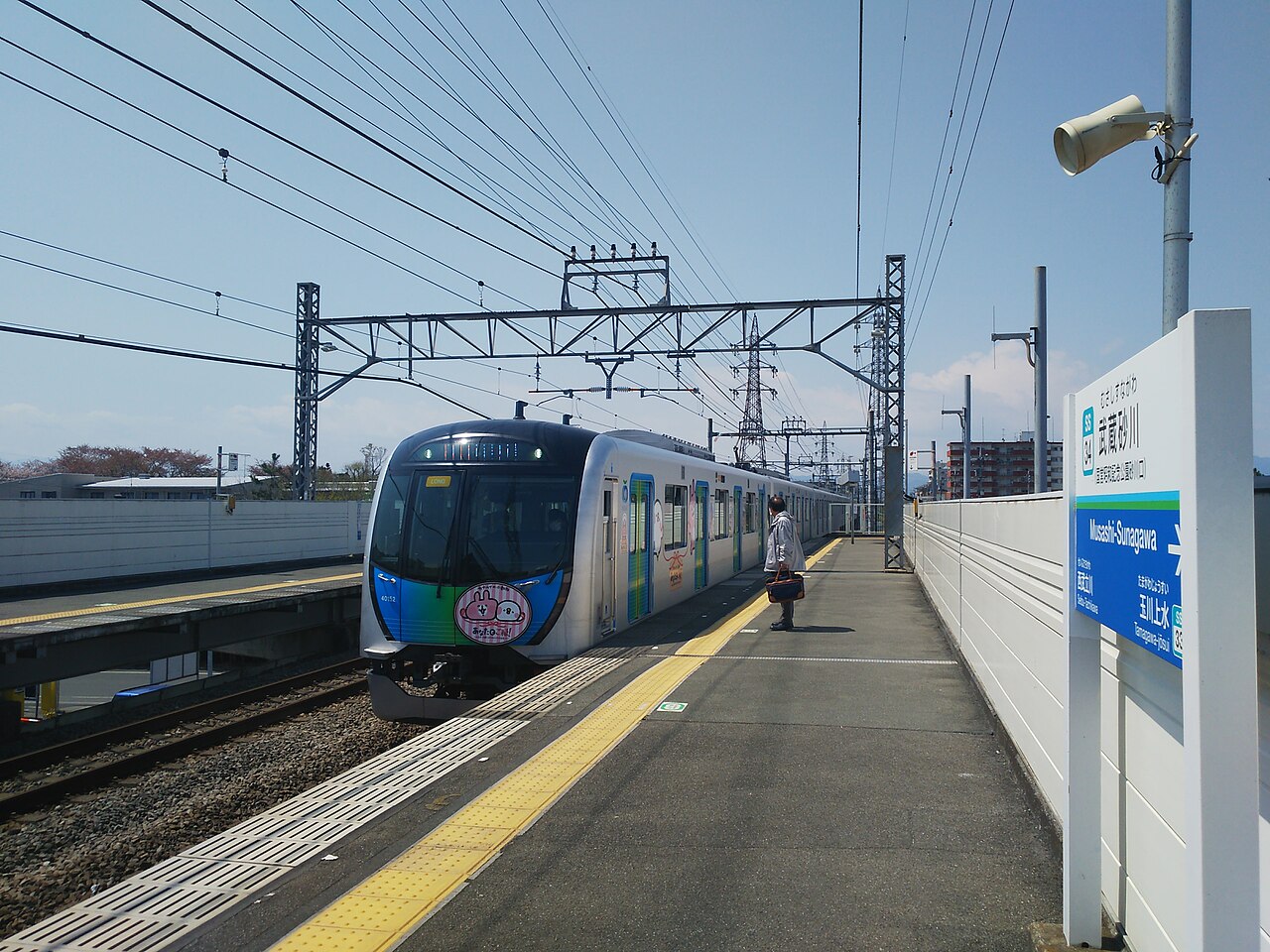 A train arriving at Musashi-Sunagawa Station on the Seibu Haijima Line; the station keeps the Sunagawa name