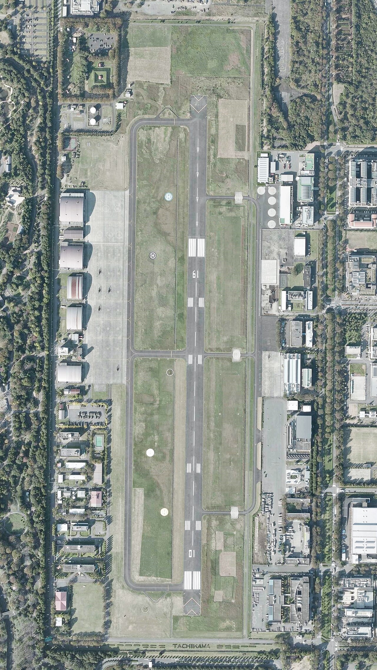 Aerial photo of Tachikawa airfield taken in 2019, its runway running straight north to south through the town