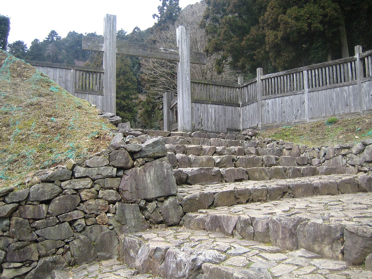 The restored stone-stepped entrance to the Goshuden site, with the posts of a gate on top.