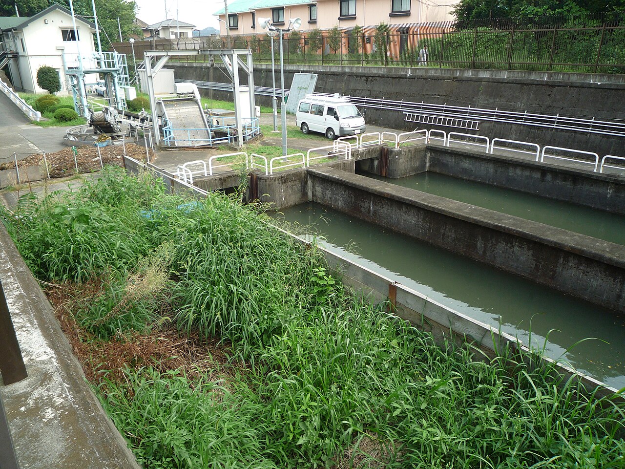 Kodaira Monitoring Station on the Tamagawa Aqueduct: concrete channels with the facility that watches the flow.