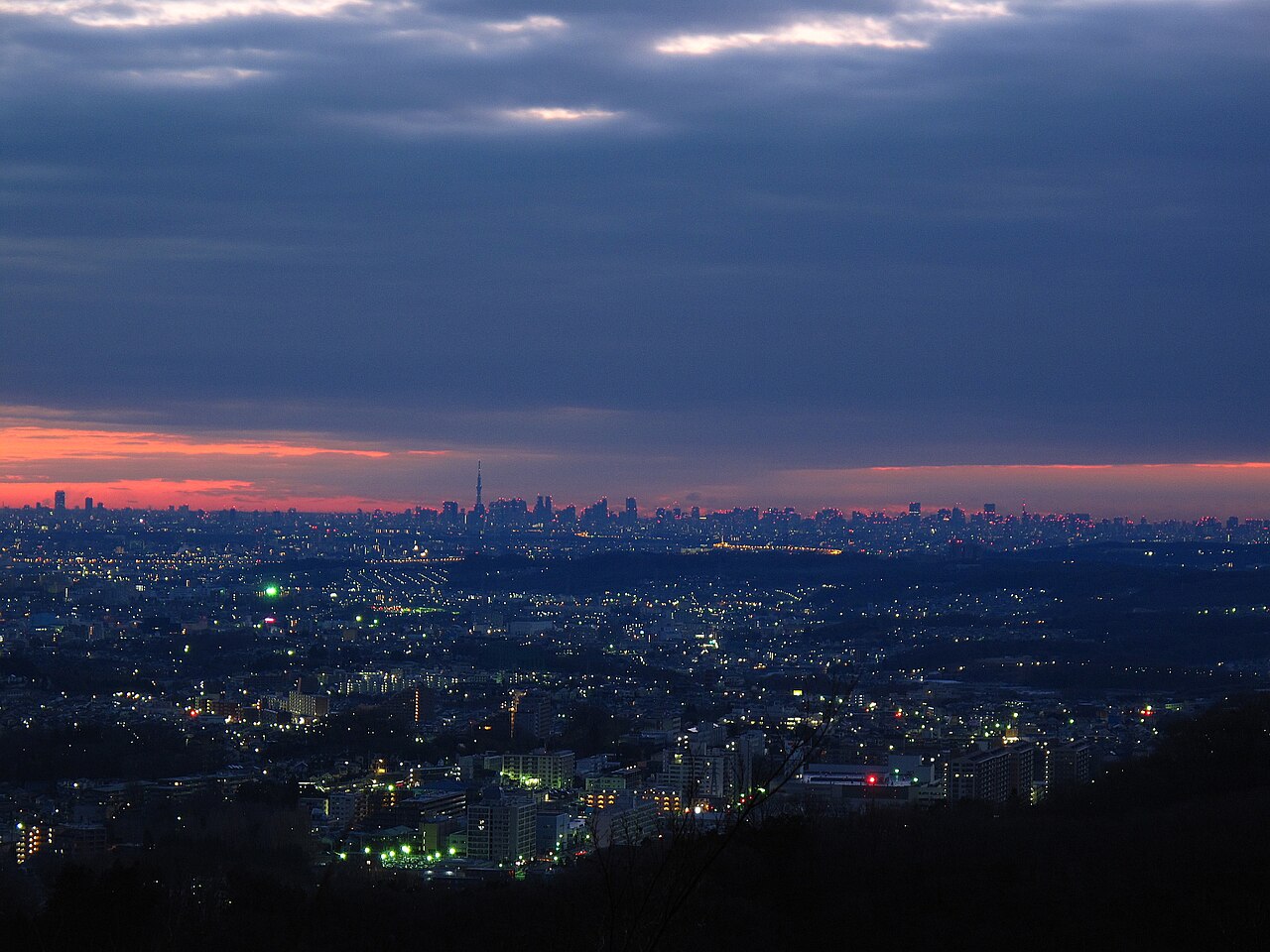 Dusk over Hachioji seen from Kompira-dai on Mount Takao, with distant high-rises of central Tokyo.