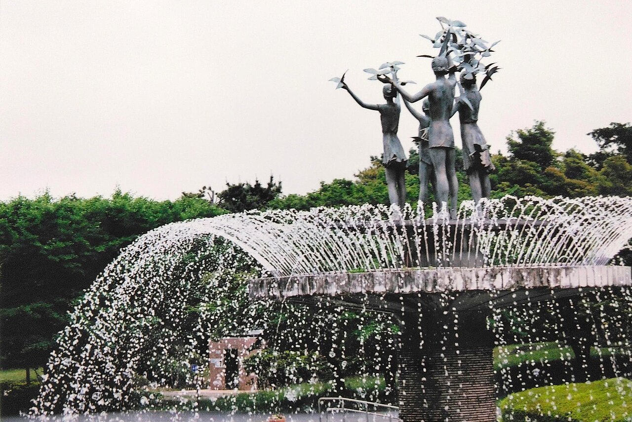 A fountain at Showa Kinen Park: a sculpted human figure stands above arcs of water.